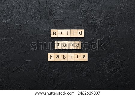 Build good habits word written on wood block. Build good habits text on table, concept.