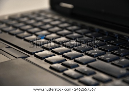 Close-Up View of a Black Notebook Keyboard on a Desk During a Productive Workday