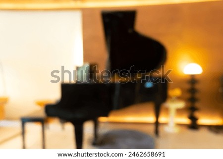 Blur image of Grand piano at concert stage,black grand piano at spot light in dark room,piano in concert hall,Musician playing piano in church,black piano,studio piano.