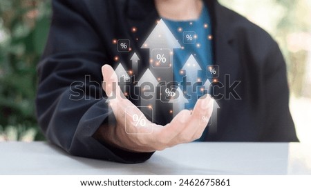 Business and investment growth concept. Businessman holding virtual upper graph increases performance with percentage icon on hand. High risk high return. 



