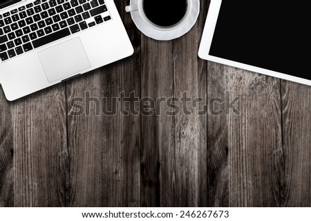 digital tablet pc, computer and cup of coffee on wooden table Royalty-Free Stock Photo #246267673