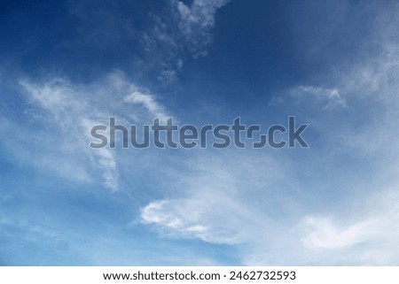 A bright blue sky background with a faint white tinge texture. Royalty-Free Stock Photo #2462732593