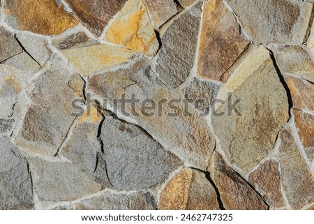 It is close up view of multicolored stone wall.  It's a photo of mosaic stones in wall. This is colorful texture for designer. 