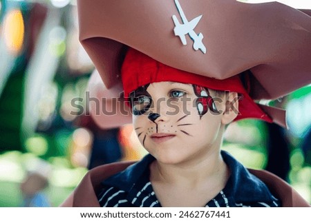 Boy Cat Pirate costume. Halloween party in kindergarten. Aqua makeup painted kids face. Bright festive