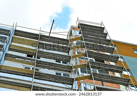 Multistage new building construction site with scaffolding
