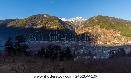 High-resolution stock images of Manali city view in front of snow-covered mountains from a hotel room