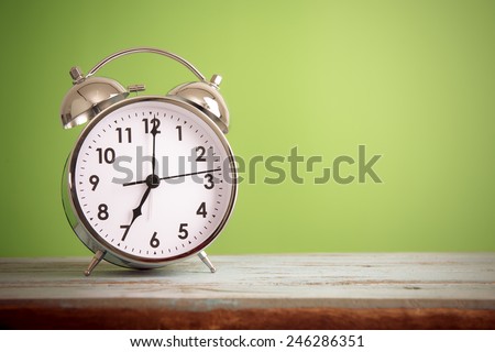 Retro alarm clock with retro colored Royalty-Free Stock Photo #246286351