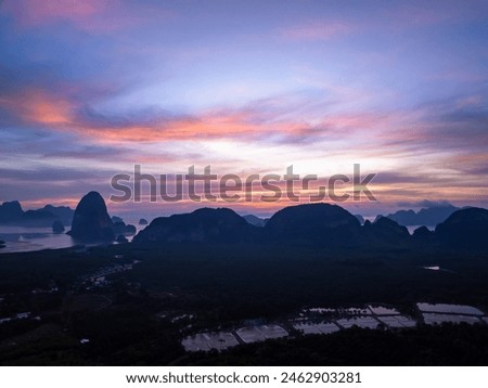 Aerial view sunrise or sunset over mountains tropical rainforest,Bird eye view image over the clouds,Amazing nature background with sea and mountains peaks in Thailand