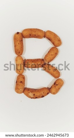 Bite of Bliss - Indulge in the art of food typography with this crisp, ‘B’-shaped snack, poised against a pristine backdrop—ideal for design and culinary expressions