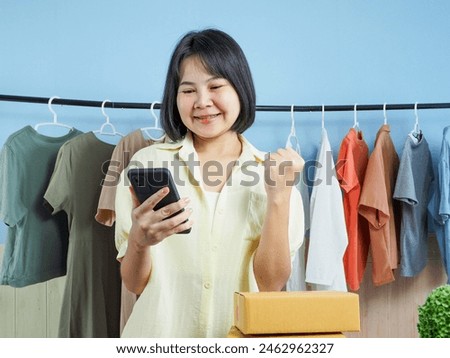 Small business selling clothes Asian woman shop owner runs a small e-commerce business Be cheerful and happy that online product sales are increasing.