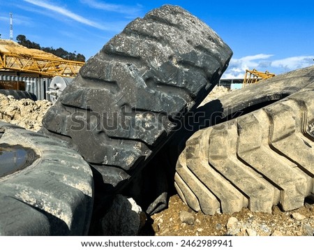 huge piles of used tires discarded on the ground