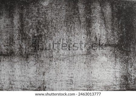 The wall is a rough white surface with black stains on it. Ideas for textured images, chalkboards, free space for text. and decorative patterns