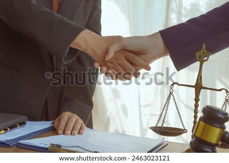 Shaking hands, A group of lawyers and clients engage in a professional meeting at a law office, discussing agreements, contracts, and legal matters with a focus on justice and expert advice.
