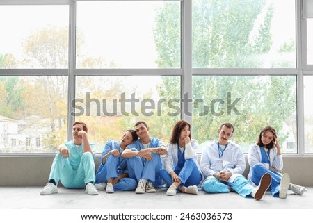 Team of doctors sitting in hall of clinic