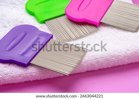 Three combs for removing lice and nits on lilac background
