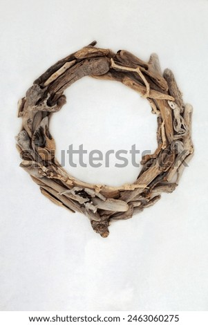 Driftwood wreath abstract round shape art sculpture on hemp paper background. Creative natural wood nature composition.