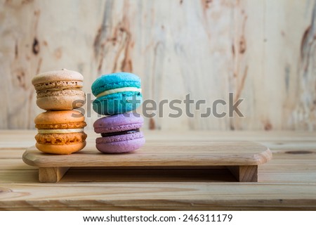 macarons on table over wooden background. 