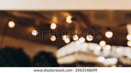 Decorative outdoor string lights at night time, Defocused Background, night city life backdrop, party time with Yellow bokeh balls