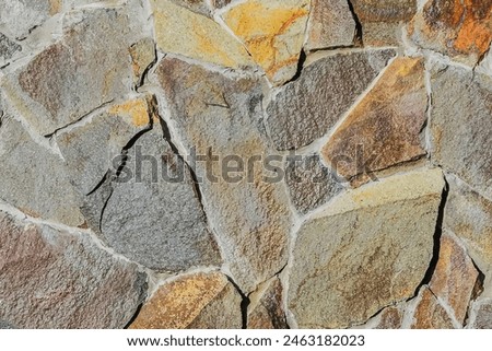 It is close up view of multicolored stone wall.  It's photo of mosaic stones in wall. This is the colorful texture for designer. 
