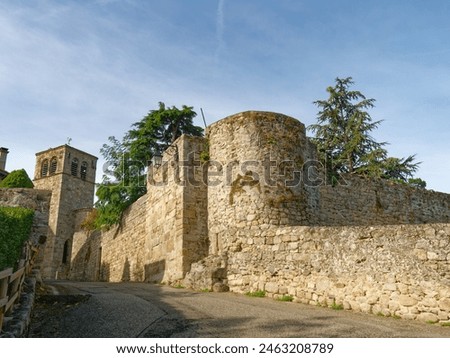 Remaining medieval fortifications in Montagny (France), in "Rue de la Grand Croix" (street of the great cross), with church in the background