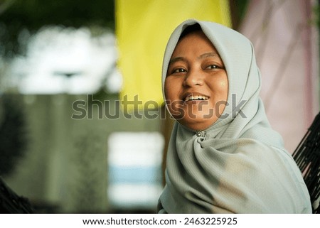 Asian woman wearing hijab is relaxing enjoying nature