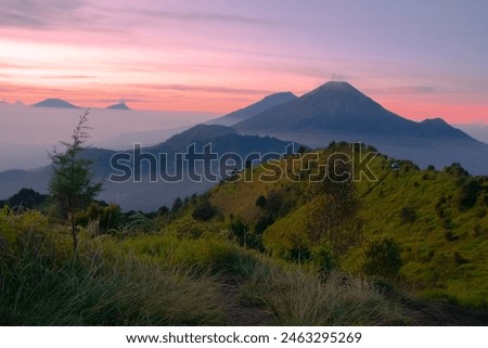 A landscape photography of Mount Prau in Central Java, stunning golden sunrise, beautifull mountain range