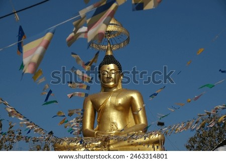 big golden buddha and flags