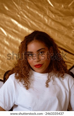 portrait latin american black woman shiny gold background white blouse self-portrait