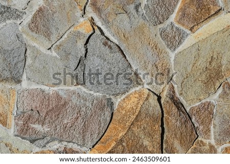 It is close up view of multicolored stone wall.  It's the photo of mosaic stones in wall. This is colorful texture for designer. 