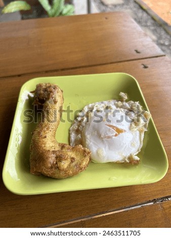 FRIED CHICKEN HEAD WITH HALF-BOOKED EGGS