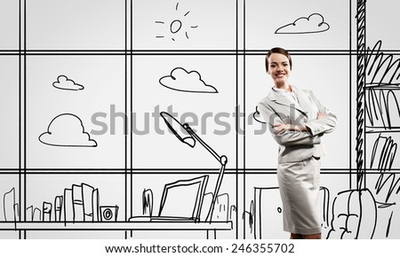 Young confident businesswoman standing in drawn office