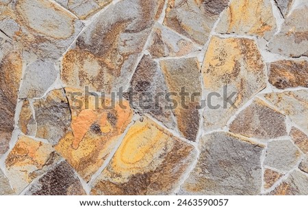 It's photo of mosaic stones in wall. It is close up view of multicolored stone wall. This is the colorful texture for designer. 