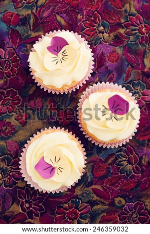 Cupcakes with buttercream and pansy sugar flowers