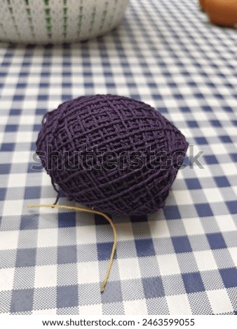 A spool of purple thread on the table