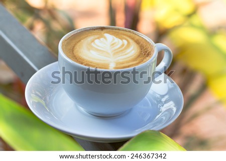 hot cup of coffee latte art on steel