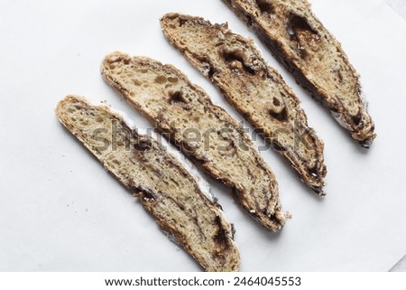 Overhead view of sliced date jam filled bread, flatlay of date filled bread slices on white background Royalty-Free Stock Photo #2464045553