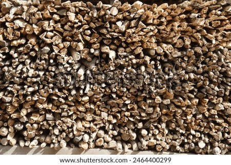 Texture and background of the surface of the pile of wood. Pile of sawed firewood. Rustic wood texture surface and structure. 