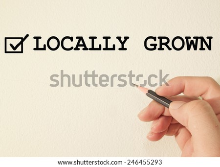 locally grown check mark on wall background 