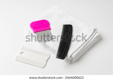 Anti lice combs and towel on white background