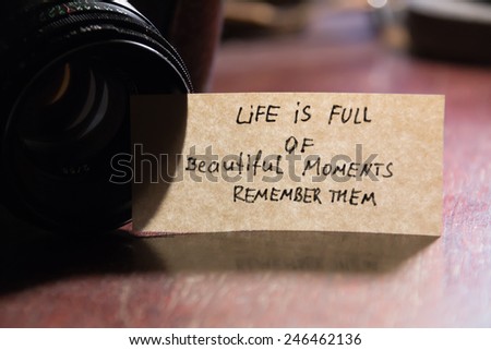photo camera and quote "life is full of beautiful moments - remember them"