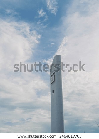 tower or mosque minaret with calligraphy ornaments and blue sky