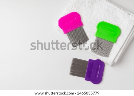 Anti lice combs and towel on white background