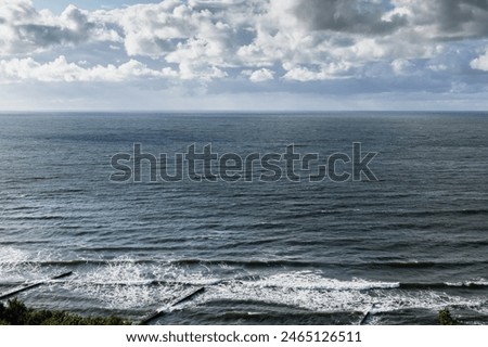 Baltic Sea coastal view with breakwaters and shore water under stormy cloudy sky on a daytime. Landscape of Svetlogorsk, Kaliningrad Oblast, Russia