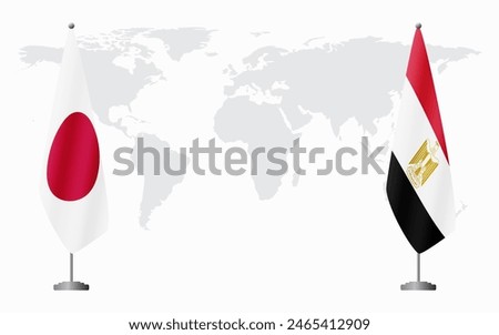 Japan and Egypt flags for official meeting against background of world map.