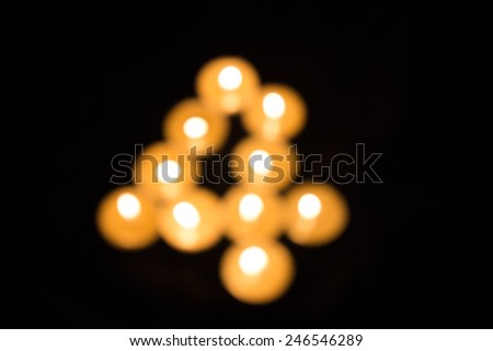 Number Four of Abstract blur of candles on a dark background