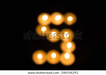 Number five of Abstract blur of candles on a dark background