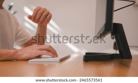 Hands of an office man typing on computer keyboard, Freelance working remote concept, Hands typing on computer keyboard in office desk or living room area at home
