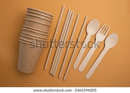 Kraft paper tableware: cups, food boxes, isolated on a light background. A set of various disposable tableware. Recycling and zero waste concept. Mock up