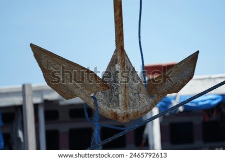 An iron anchor attached to a wooden ship