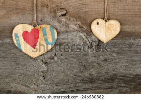 Love Valentines message two wooden hearts sign from recycled old palette on rough grey wood background, copy space
